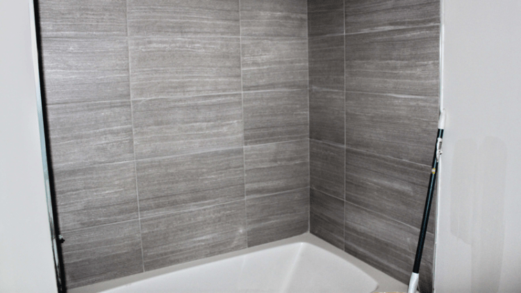 Gray bathroom tile installed